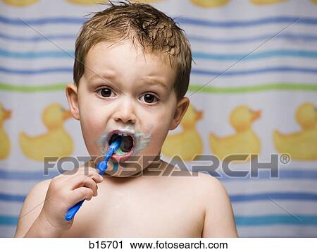 Boy brushing teeth in bathroom View Large Photo Image Stock Image - Boy brushing teeth in bathroom. Fotosearch