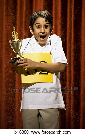 Boy contestant holding trophy View Large Photo Image Stock Image - Boy contestant holding trophy. Fotosearch