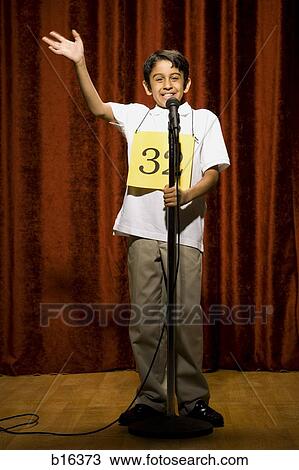 Boy contestant standing at microphone waving and smiling View Large Photo Image Stock Image - Boy contestant standing at microphone waving and smiling. Fotosearch