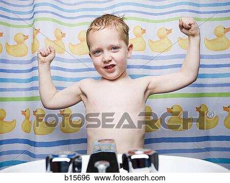 Boy flexing muscles in bathroom View Large Photo Image Stock Photograph - Boy flexing muscles in bathroom. Fotosearch