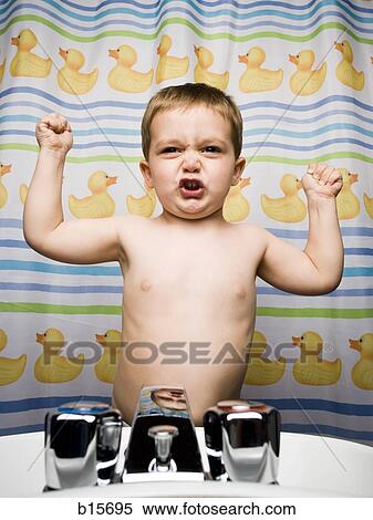 Boy flexing muscles in bathroom View Large Photo Image Stock Photography - Boy flexing muscles in bathroom. Fotosearch