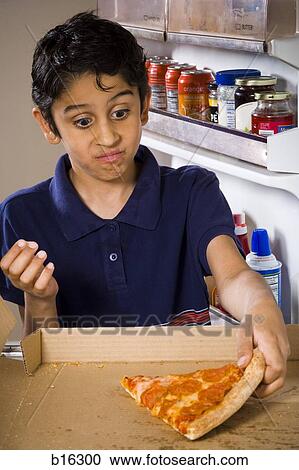 Boy getting slice of pepperoni pizza from refrigerator View Large Photo Image Stock Image - Boy getting slice of pepperoni pizza from refrigerator. Fotosearch