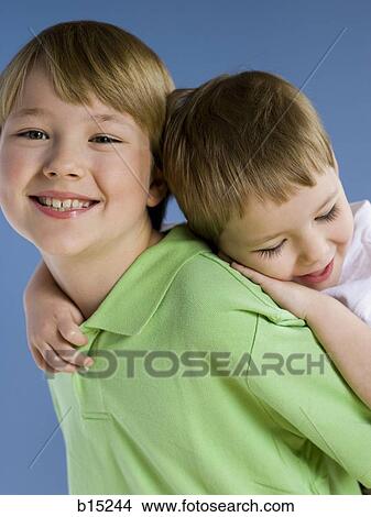 Boy giving boy piggyback ride View Large Photo Image Picture - Boy giving boy piggyback ride. Fotosearch