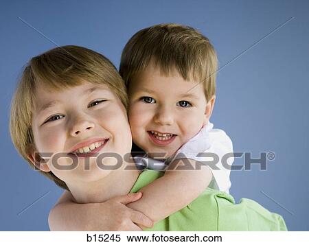 Boy giving boy piggyback ride View Large Photo Image Stock Photography - Boy giving boy piggyback ride. Fotosearch