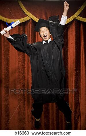 Boy graduate with mortar board and diploma smiling with braces and cheering View Large Photo Image Stock Image - Boy graduate with mortar board and diploma smiling with braces and cheering. Fotosearch