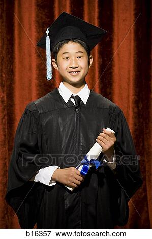 Boy graduate with mortar board and diploma smiling with braces View Large Photo Image Stock Photo - Boy graduate with mortar board and diploma smiling with braces. Fotosearch