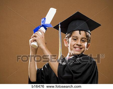 Stock Photograph - Boy graduate with mortar board and diploma smiling. Fotosearch