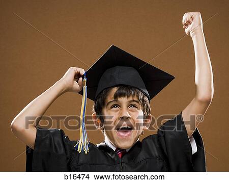 Boy graduate with mortar board smiling and cheering View Large Photo Image Picture - Boy graduate with mortar board smiling and cheering. Fotosearch