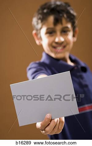 Boy holding blank card smiling View Large Photo Image Stock Photo - Boy holding blank card smiling. Fotosearch