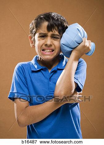 Boy holding ice pack to head View Large Photo Image Stock Photo - Boy holding ice pack to head. Fotosearch