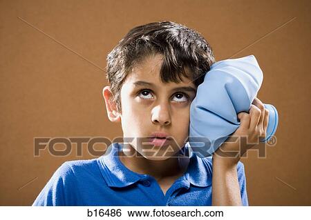 Boy holding ice pack to head View Large Photo Image Stock Photograph - Boy holding ice pack to head. Fotosearch