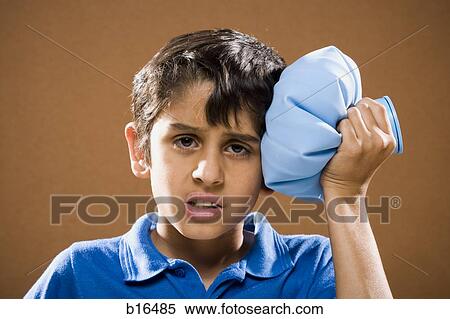 Boy holding ice pack to head View Large Photo Image Stock Photography - Boy holding ice pack to head. Fotosearch