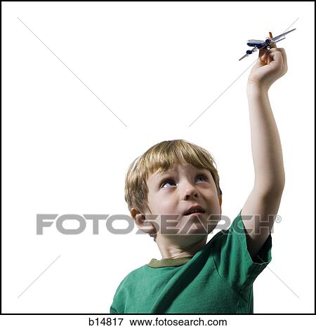 Boy holding toy airplane View Large Photo Image Stock Photo - Boy holding toy airplane. Fotosearch