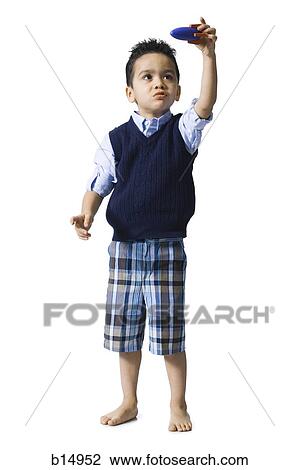 Boy holding toy boat View Large Photo Image Stock Image - Boy holding toy boat. Fotosearch