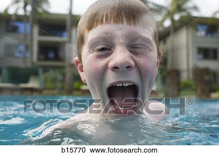 Boy in outdoor pool making funny face View Large Photo Image Stock Image - Boy in outdoor pool making funny face. Fotosearch