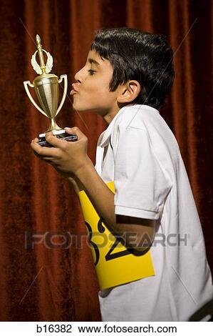 Boy kissing trophy cup View Large Photo Image Stock Image - Boy kissing trophy cup. Fotosearch