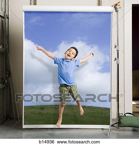 Boy leaping with blue sky and grass View Large Photo Image Stock Photograph - Boy leaping with blue sky and grass. Fotosearch