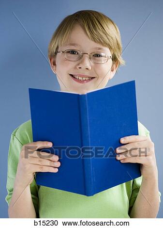 Boy reading book and smiling View Large Photo Image Stock Image - Boy reading book and smiling. Fotosearch