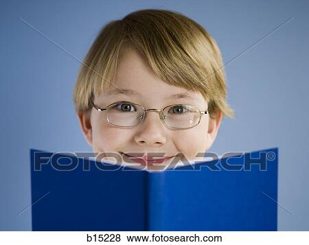Boy reading book and smiling View Large Photo Image Stock Photo - Boy reading book and smiling. Fotosearch