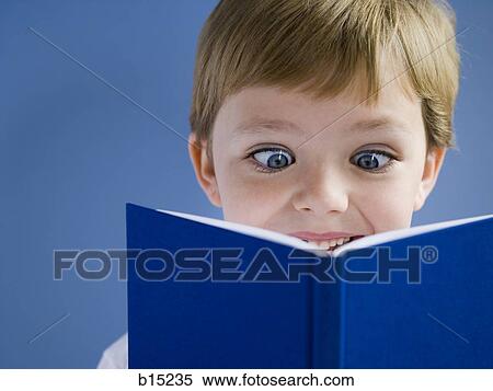Boy reading book and smiling View Large Photo Image Stock Photography - Boy reading book and smiling. Fotosearch