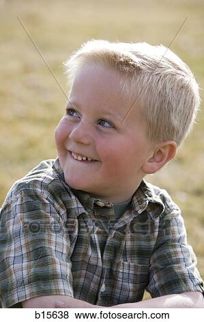 Stock Photo - Boy smiling outdoors. Fotosearch