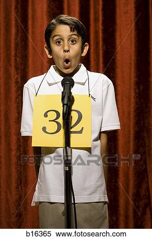 Boy standing at microphone speaking with number around neck View Large Photo Image Stock Photography - Boy standing at microphone speaking with number around neck. Fotosearch
