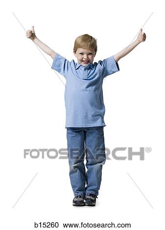 Stock Image - Boy standing with thumbs up smiling. Fotosearch