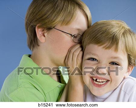 Boy whispering and smiling View Large Photo Image Stock Image - Boy whispering and smiling. Fotosearch
