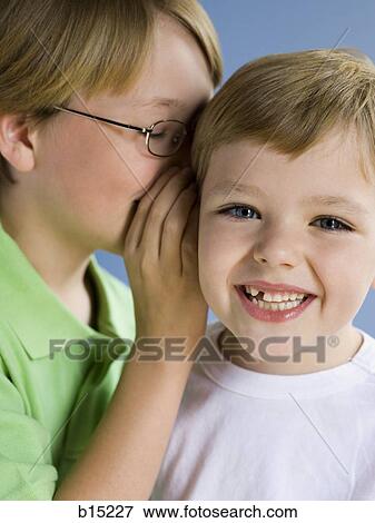 Boy whispering and smiling View Large Photo Image Stock Photo - Boy whispering and smiling. Fotosearch