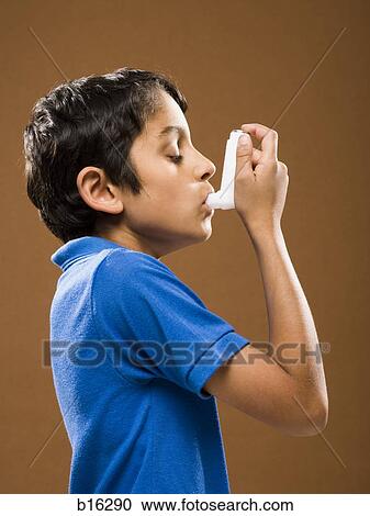 Stock Image - Boy with asthma inhaler profile. Fotosearch