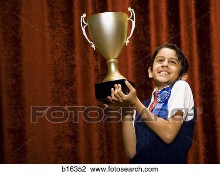 Boy with blue ribbon and trophy cup smiling View Large Photo Image Stock Image - Boy with blue ribbon and trophy cup smiling. Fotosearch