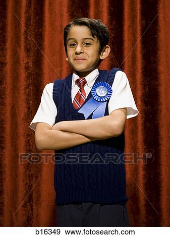 Stock Photo - Boy with blue ribbon smiling with arms crossed. Fotosearch