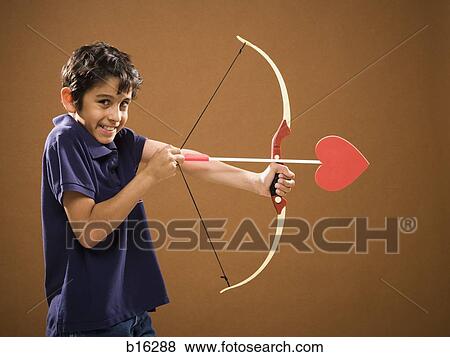 Boy with bow and arrow with heart on it View Large Photo Image Stock Photo - Boy with bow and arrow with heart on it. Fotosearch