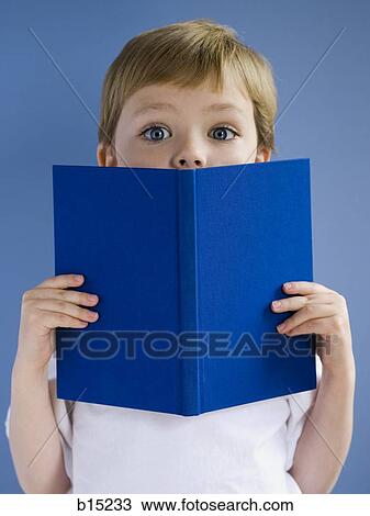 Stock Image - Boy with hardcover book. Fotosearch