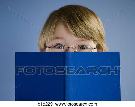 Boy with hardcover book View Large Photo Image Stock Photo - Boy with hardcover book. Fotosearch