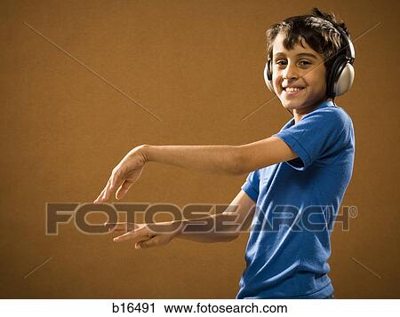 Boy with headphones smiling and waving hands View Large Photo Image Stock Image - Boy with headphones smiling and waving hands. Fotosearch