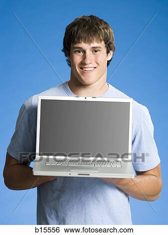 Stock Photograph - Boy with laptop smiling. Fotosearch