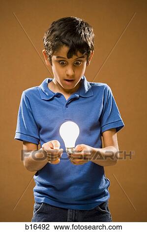Boy with lightbulb and wire View Large Photo Image Stock Image - Boy with lightbulb and wire. Fotosearch