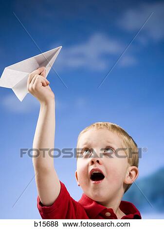 Boy with paper airplane outdoors View Large Photo Image Stock Photo - Boy with paper airplane outdoors. Fotosearch