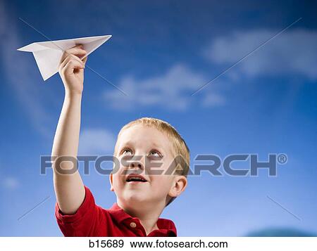 Boy with paper airplane outdoors View Large Photo Image Stock Photo - Boy with paper airplane outdoors. Fotosearch