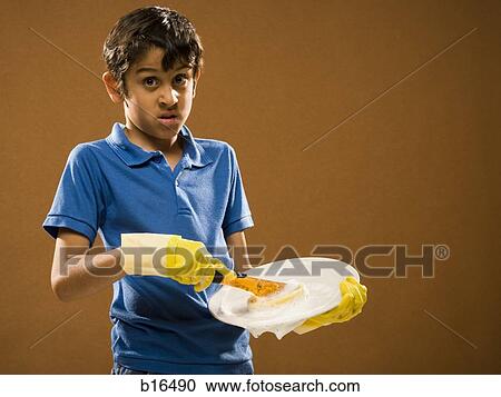 Boy with rubber gloves scrubbing plate View Large Photo Image Stock Image - Boy with rubber gloves scrubbing plate. Fotosearch
