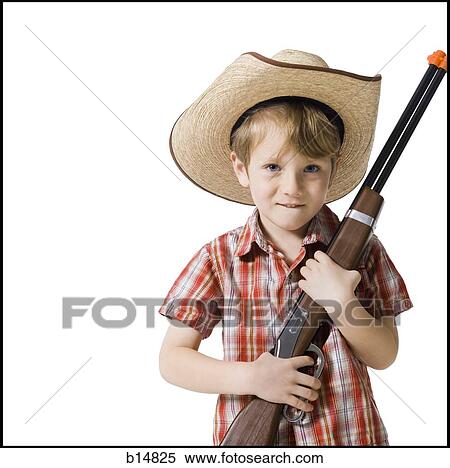 Boy with toy rifle and cowboy hat View Large Photo Image Stock Photography - Boy with toy rifle and cowboy hat. Fotosearch