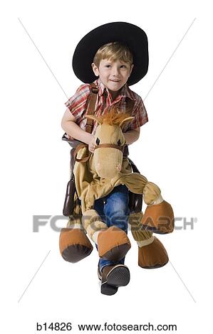 Boy with toy rifle and horse with cowboy hat View Large Photo Image Stock Photograph - Boy with toy rifle and horse with cowboy hat. Fotosearch
