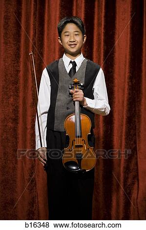 Stock Photo - Boy with violin and bow smiling. Fotosearch