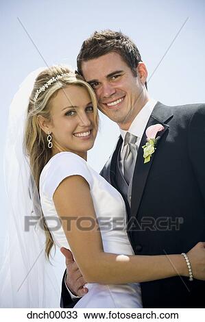 Bride and groom hugging and smiling View Large Photo Image Stock Image - Bride and groom hugging and smiling. Fotosearch