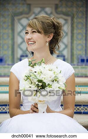 Bride sitting on steps with bouquet smiling View Large Photo Image Stock Image - Bride sitting on steps with bouquet smiling. Fotosearch