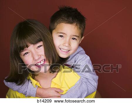 Stock Photo - Brother and Sister hugging.. Fotosearch