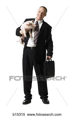 Businessman holding briefcase and piglet View Large Photo Image Stock Photography - Businessman holding briefcase and piglet. Fotosearch
