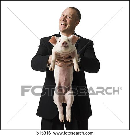 Businessman holding piglet View Large Photo Image Stock Photograph - Businessman holding piglet. Fotosearch