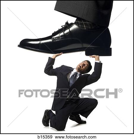 Businessman kneeling and holding up large dress shoe View Large Photo Image Stock Photo - Businessman kneeling and holding up large dress shoe. Fotosearch
